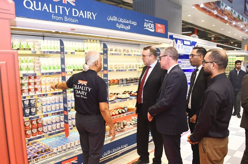A group of men looking at dairy products in Lulu Hypermarket.